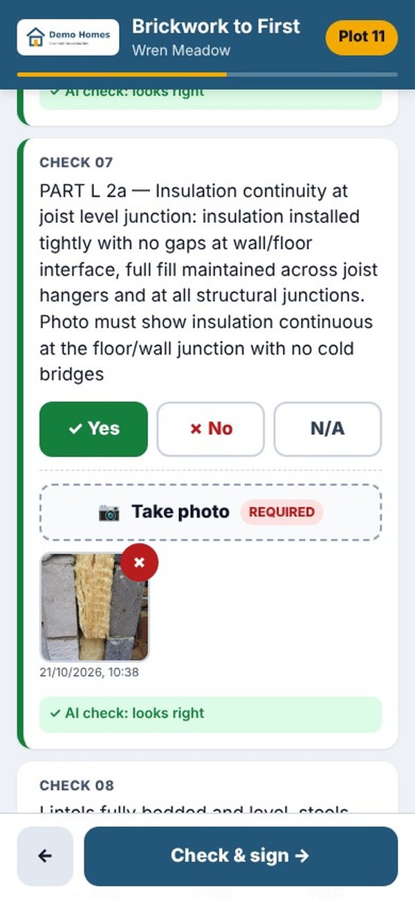 A trade's phone showing a Part L check with a time-stamped photo and the AI check saying it looks right